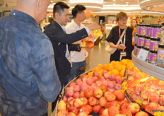 At retailer 3hrsixty in Hong Kong Sam Sin (white shirt) from Freco Int. Hong Kong, who are importers from around the world, showing Vietnam exporters from Central Retail retail and Thailand importer the local retail setup. They are looking at what is in season now and on display for them to export to Hong Kong.